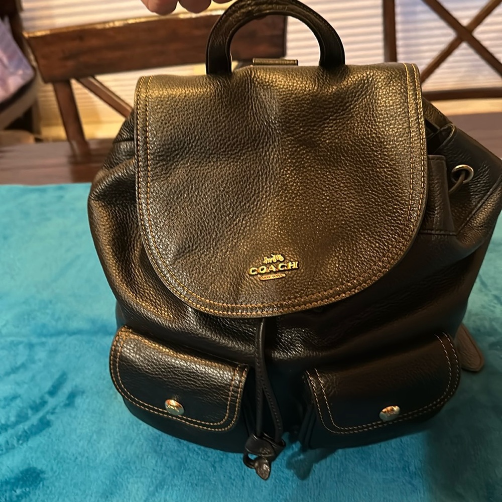 COACH Ladies leather drawstring backpack - Black. 2 ext, 3 interior pockets.